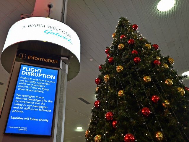 An information board announces flight disruption at London Gatwick Airport, south of London, on December 20, 2018 after all flights were grounded due to drones flying over the airfield. - London Gatwick Airport was forced to suspend all flights on December 20 due to drones flying over the airfield, causing …