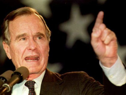 Former President George H.W. Bush pointing up
