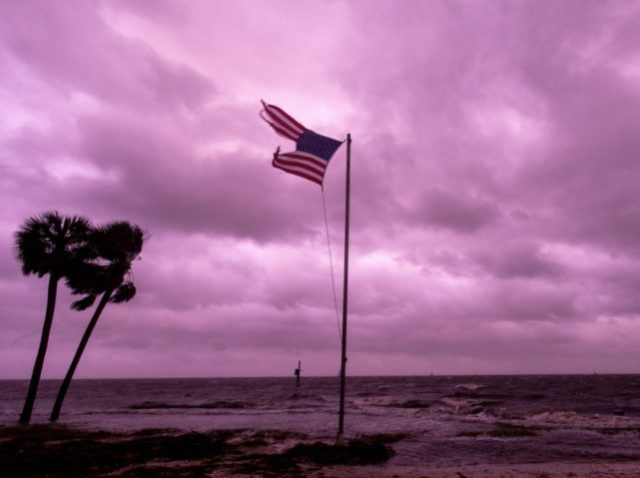 CRAWFORDVILLE - OCTOBER 10: An American flag battered by Hurricane Michael continues to fly in the in the rose colored light of sunset at Shell Point Beach on October 10, 2018 in Crawfordville, Florida.The hurricane hit the Florida Panhandle as a category 4 storm. (Photo by Mark Wallheiser/Getty Images)