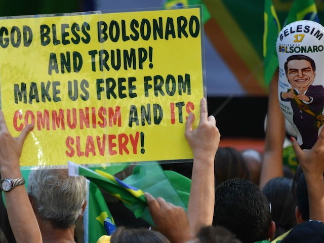 Supporters of Brazilian right-wing presidential candidate Jair Bolsonaro take part in a rally along Paulista Avenue in Sao Paulo Brazil on October 21 2018. - Barring any last-minute upset, Brazil appears poised to elect Jair Bolsonaro, a populist far-right veteran politician, as its next president in a week's time. (Photo …