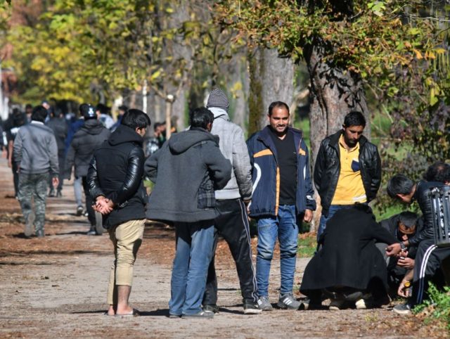 Groups of African and Asian migrants are seen gathering, in a park, near migrants centers in Northern-Bosnian town of Bihac, on October 25, 2018. - In their struggle with large number of in coming migrants, Bosnian authorities have provided two additional capacities, in abandoned army barracks in Hadzici and a …