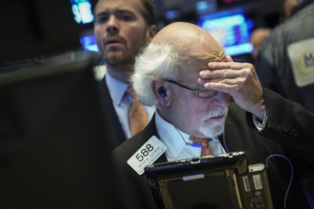 NEW YORK, NY - NOVEMBER 12: Traders and financial professionals work at the closing bell o