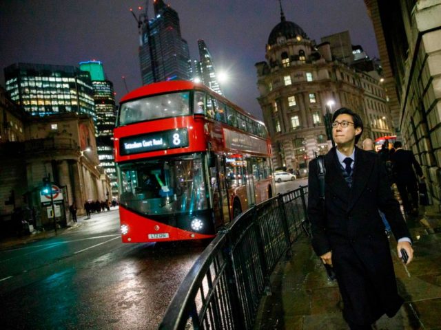 A red London bus makes it's way through the City of London on November 28, 2018 (Phot