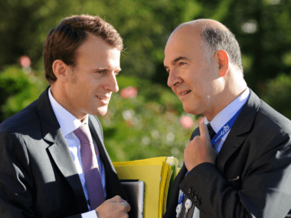 French President's deputy General Secretary Emmanuel Macron (L) and French Economy, Finance and Foreign Trade Minister Pierre Moscovici (R) chat during the G20 summit on September 6, 2013 in Saint Petersburg. AFP PHOTO / JACQUES WITT (Photo credit should read JACQUES WITT/AFP/Getty Images)