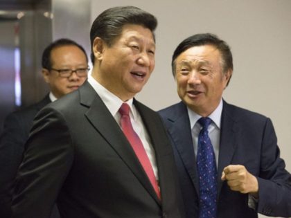 Chinese President Xi Jinping (L) is shown around the offices of Chinese tech firm Huawei t