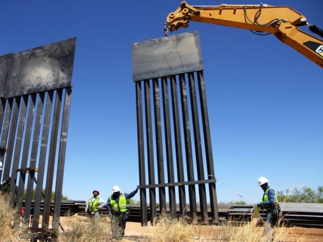 TOPSHOT - Workers replace an old section of the wall between the US and Mexico following orders by US President Donald Trump, in Santa Teresa, New Mexico State, US, close to Ciudad Juarez in Mexico's Chihuahua State, on April 23, 2018. (Photo by Herika MARTINEZ / AFP) (Photo credit should …