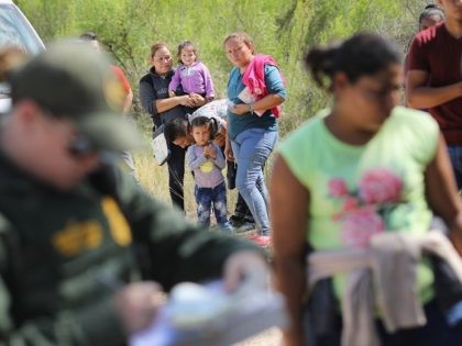 MCALLEN, TX - JUNE 12: Central American asylum seekers wait as U.S. Border Patrol agents t