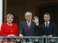 GettyImages-978800558 GRANSEE, GERMANY - JUNE 19: German Chancellor Angela Merkel and French President Emmanuel Macron greet EU commission president Jean-Claude Juncker at Schloss Meseberg governmental palace during German-French government consultations on June 19, 2018 near Gransee, Germany. Merkel, Macron and a selection of their government ministers are coming together today for …