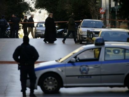 A Greek Orthodox priest arrives after an explosion at the Orthodox church of Agios Dionysios in the upscale Kolonaki area of Athens, Thursday, Dec. 27, 2018. Police in Greece say an officer has been injured in a small explosion outside a church in central Athens while responding to a call …