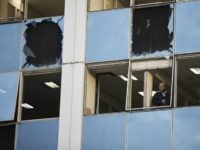 Greek terrorism A journalist looks out a broken window after a powerful bomb exploded outside private Greek television station Skai, in Faliro, Athens, on Monday, Dec, 17, 2018. Police said the blast occurred outside the broadcasters' headquarters near Athens after telephoned warnings prompted authorities to evacuate the building, causing extensive damage but …