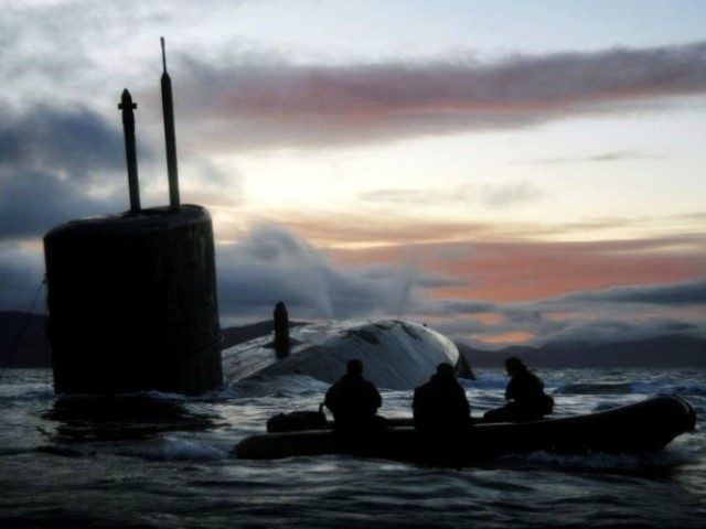 Observers watch the Royal Navy submarine HMS Talent conducting Dive and Surface Drills in the Kyle of Localsh, Scotland in 2009.