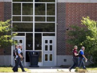Indiana-middle-school-police-ap Law enforcement officers walk outside Noblesville West Middle School in Noblesville, Ind., after a shooting on Friday, May 25, 2018. A male student opened fire at the suburban Indianapolis school wounding another student and a teacher before being taken into custody, authorities said. (Robert Scheer/The Indianapolis Star via AP)