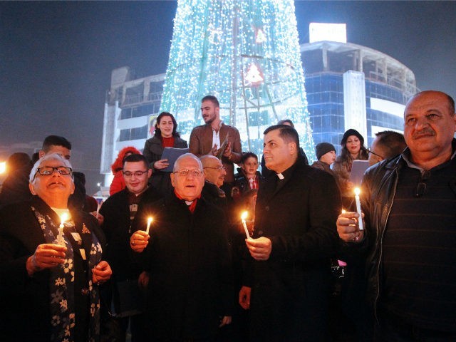 Iraqis gather at the al-Mansour square with Archbishop Louis Sako (C), patriarch of the Ch