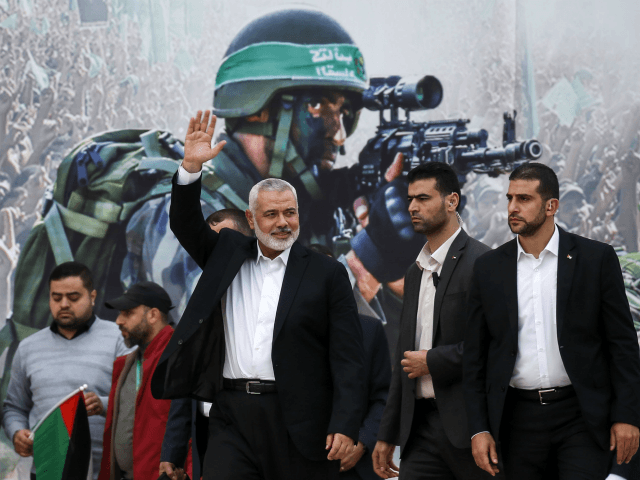 Gaza Hamas leader Ismail Haniya (3rd-R) waves upon his arrival at a rally marking the 31st