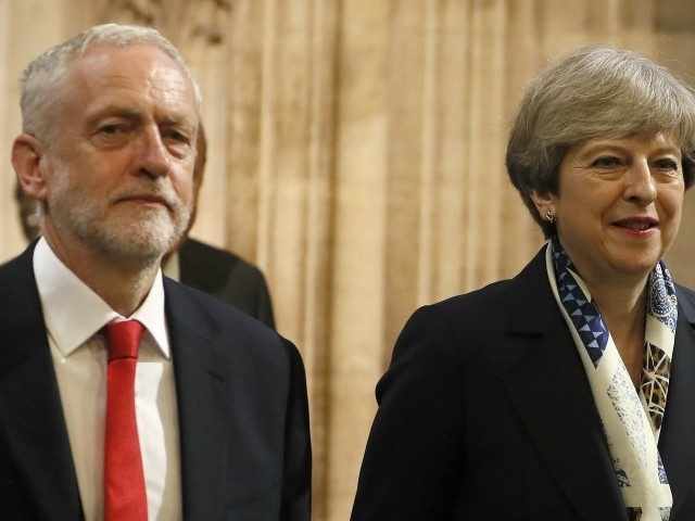 Britain's Prime Minister Theresa May and leader of the opposition Jeremy Corbyn walk throu