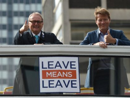 Leave Means Leave campaign co-chairs John Longworth (L) and Richard Tice gesture aboard The Leave Means Leave battle bus at an event on the sidelines of the Conservative Party Conference 2018, in Birmingham on October 1, 2018. (Photo by Oli SCARFF / AFP) (Photo credit should read OLI SCARFF/AFP/Getty Images)