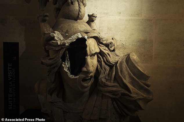 A broken sculpture of Marianne, symbol of the French Repupblic, appears damaged in the gallery inside the Arc de Triomphe during a demonstration Saturday, Dec.1, 2018 in Paris. A French protest against rising taxes and the high cost of living turned into a riot Saturday in Paris as police fired tear gas and water cannon in street battles with activists wearing the fluorescent yellow vests of a new movement. (AP Photo/Kamil Zihnioglu)