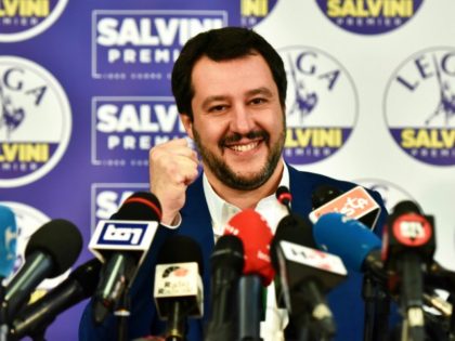 Lega far right party leader Matteo Salvini (C) smiles and rises his fist at the Lega headquarter in Milan on March 5, 2018 for a press conference ahead of the Italy's general election results. A surge for populist and far-right parties in Italy's weekend election could result in a hung …