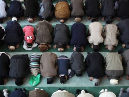 LONDON, ENGLAND - FEBRUARY 18: Muslim men pray at Baitul Futuh Mosque in Morden on Februar