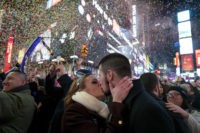 APTOPIX NYC New Years Eve Kaitlin Olivi of Yonkers, N.Y., and Lucas Pereira, of Sayreville, N.J., kiss as confetti falls during a celebration of the new year in New York's Times Square, Sunday, Jan. 1, 2017.