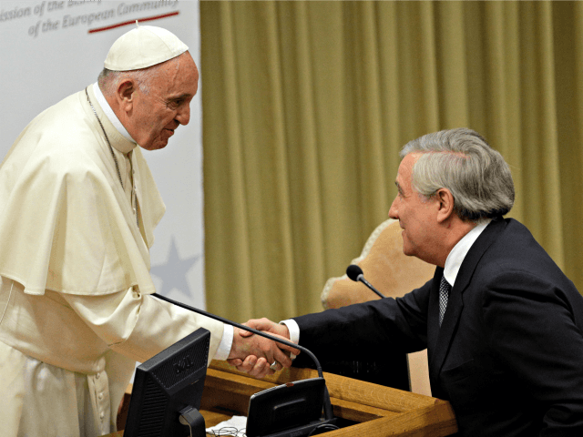 Pope Francis shakes hands with European Parliament President Antonio Tajani during a confe