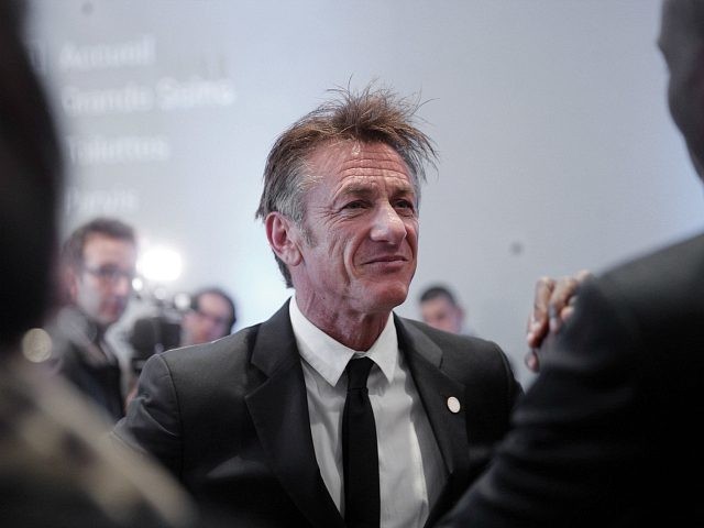 US actor Sean Penn speaks with Haiti's President Jovenel Moise at the One Planet Summ