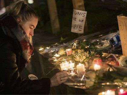 STRASBOURG, FRANCE - DECEMBER 12: A woman lights a candle at the Christmas market where the day before a man shot 14 people, killing at least three, on December 12, 2018 in Strasbourg, France. Police have identified the man as Cherif Chekatt, a French citizen on a police terror watch-list. …