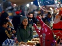 Syrian Women A woman sits next to a peddlar's stall in a market in the northeastern Syrian city of Qamishli on December 12, 2018. (Photo by Delil SOULEIMAN / AFP) (Photo credit should read DELIL SOULEIMAN/AFP/Getty Images)