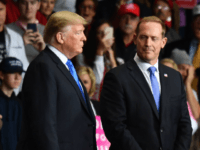 US President Donald Trump (L) and Republican Congressional candidate for North Carolina's 13th district Ted Budd (L) listen as Republican Congressional candidate for North Carolina's 9th district Mark Harris speaks during a 'Make America Great Again' rally at Bojangles' Coliseum on October 26, 2018 in Charlotte, North Carolina. (Photo by …