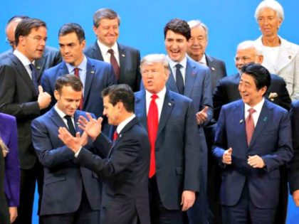President Donald Trump and other heads of state react to Mexico's President Enrique Pena Neto, throwing his hands up, being the last one to arrive for the family photo at the G20 summit, Friday, Nov. 30, 2018 in Buenos Aires, Argentina.