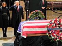 Trump Salutes George HW Bush President Donald Trump salutes alongside first lady Melania Trump in front of the flag-draped casket of former President George H.W. Bush in the Capitol Rotunda in Washington, Monday, Dec. 3, 2018.