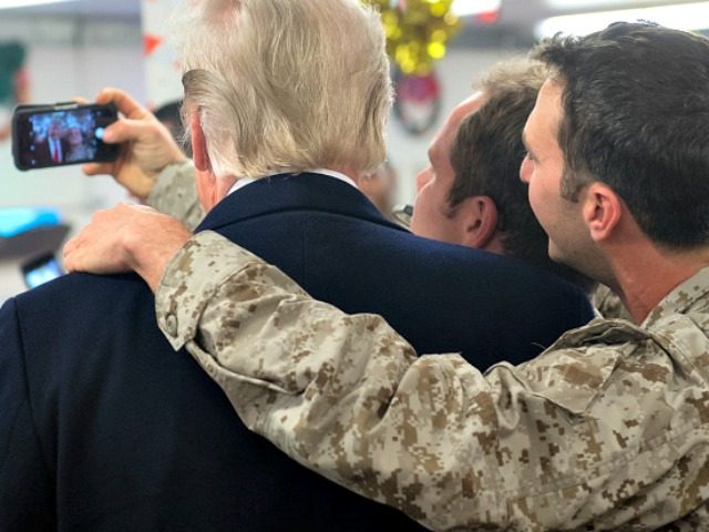 TOPSHOT - US President Donald Trump greets members of the US military during an unannounce