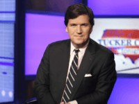 Tucker Carlson, host of "Tucker Carlson Tonight," poses for photos in a Fox News Channel studio, in New York, Thursday, March 2, 2107. (AP Photo/Richard Drew)