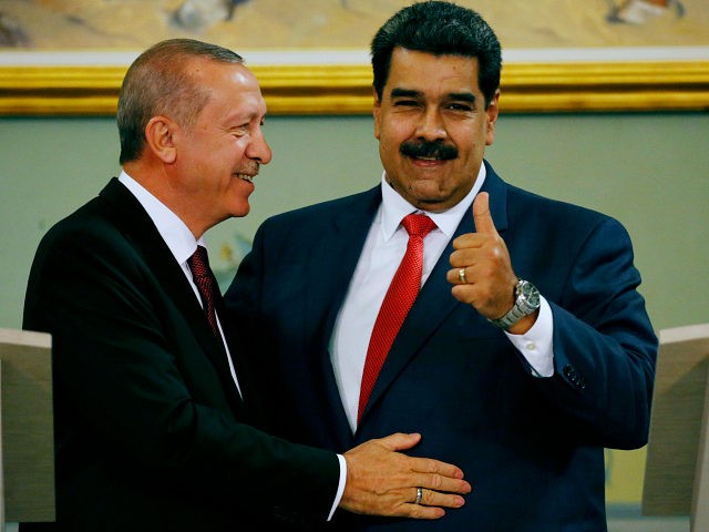 Venezuela's President Nicolas Maduro gives a thumbs up next to Turkey's President Recep Ta