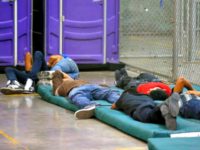 UACs Children sleep on cots in the temporary processing center in Nogales.