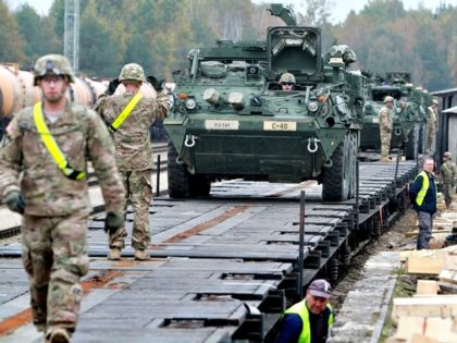 Members of the US Army 1st Brigade, 1st Cavalry Division, unload Stryker Armored Vehicles at the railway station near the Rukla military base in Lithuania, on October 4, 2014. Lithuania will increase its defence budget by a third next year amid concerns over a resurgent Russia, but spending will still …