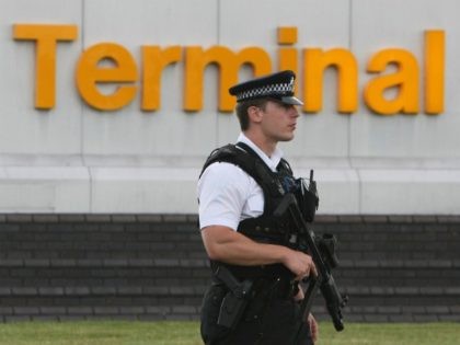 LONDON - JULY 03: An armed police officer stands guard at Terminal 4, Heathrow Airport on July 3, 2007 in London, England. Officials at Heathrow Terminal 4 have confirmed they have a suspect bag which has caused major disruption to the travel network. (Photo by Daniel Berehulak/Getty Images)