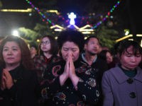 Chinese Catholics attend a mass on Holy Saturday, part of Easter celebrations at Beijing's government sanctioned South Cathedral on March 31, 2018. Chinese Catholics are taking part in Easter celebrations as China and the Vatican continue talks on a historic agreement on the appointment of bishops in China. / AFP …