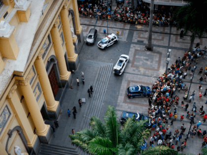 Aerial view showing people gathering outside the Cathedral of Campinas, 90 km northwest of Sao Paulo, Brazil, on December 11, 2018, after a man opened fire during mass and killed at least four people before committing suicide. - Paramedics told media the man fired a revolver and a .38-caliber pistol …