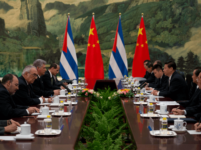 China's President Xi Jinping (centre R) attends a meeting with Cuba's First Vice President of the Council of State Miguel Diaz-Canel (centre L) at the Great Hall of the People on June 18, 2013. Diaz-Canel is on an official visit to China from June 17 to 19. AFP PHOTO / …
