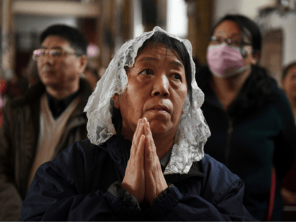 Catholic worshippers attend a mass on Holy Thursday, ahead of Easter celebrations, at Beijing's government-sanctioned South Cathedral in Beijing on March 29, 2018. A historic agreement between the Vatican and Beijing on the appointment of bishops in China could be signed as early as March 31, a Chinese government-approved bishop …
