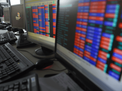 A stock trader watches share prices on his screen at a brokerage house in Mumbai on July 26, 2018. - Asian stocks mostly fell on July 26 as investor relief at US President Donald Trump and the European Commission chief's plan to ease trade tensions was offset by disappointing Wall …