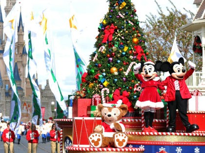 LAKE BUENA VISTA, FL - DECEMBER 01: In this handout photo provided by Disney, Mickey and Minnie Mouse wave to the crowd while taping the 'Disney Parks Christmas Day Parade' TV special in the Magic Kingdom park at Walt Disney World on December 1,2012 in Lake Buena Vista, Florida. The …