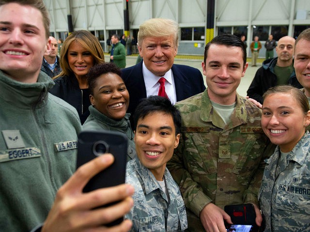 US President Donald Trump and First Lady Melania Trump greet members of the US military during a stop at Ramstein Air Base in Germany, on December 27, 2018. - President Donald Trump used a lightning visit to Iraq -- his first with US troops in a conflict zone since being …