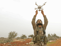 A Turkish-backed Syrian rebel fighter uses a drone at a monitoring point near the Syrian village of Qilah, in the southwestern edge of the Afrin region close to the border with Turkey, on January 22, 2018. Turkish forces began shelling the YPG enclave of Afrin from frontier Hatay province, according …
