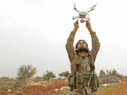 A Turkish-backed Syrian rebel fighter uses a drone at a monitoring point near the Syrian v