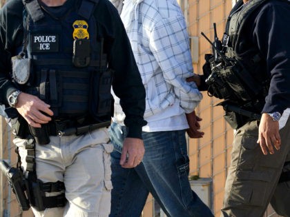 In this March 30, 2012 photo, Immigration and Customs Enforcement (ICE) agents take a suspect into custody as part of a nationwide immigration sweep in Chula Vista, Calif. Federal officials say they arrested more than 3,100 immigrants convicted of serious crimes and fugitives in a six-day nationwide sweep. Officials at …