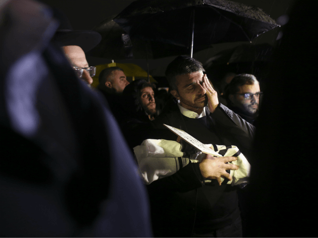 People attend the funeral of a baby who died after being prematurely delivered after her m