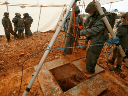 A picture taken on December 19, 2018 during a guided tour by the Israeli army shows an Israeli soldier operating a pulley while standing outside an entry point made by the army to intercept a tunnel which reportedly connects between Lebanon and Israel, near the border near the northern Israeli …