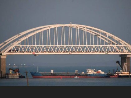 A ship under the the Kerch bridge blocks the passage to the Kerch Strait near Kerch, Crimea, Sunday, Nov. 25, 2018. Russia and Ukraine traded accusations over an incident at sea Sunday near the disputed Crimean Peninsula, increasing tensions between both countries and prompting Moscow to block passage through the …